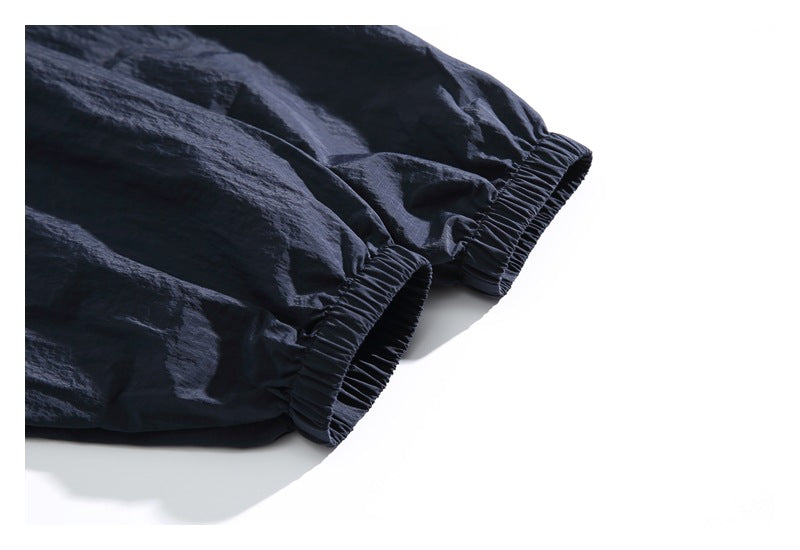 Close-up of the dark jacket's gathered elastic sleeve cuffs.