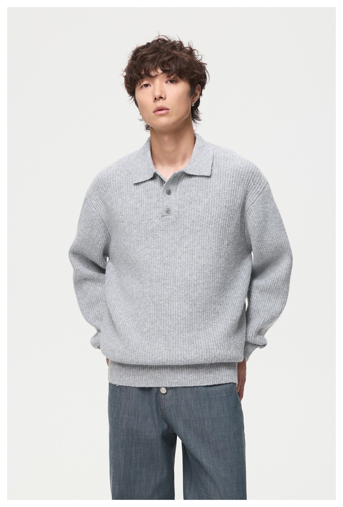 Man wearing a light gray ribbed polo sweater with buttoned placket, close front view
