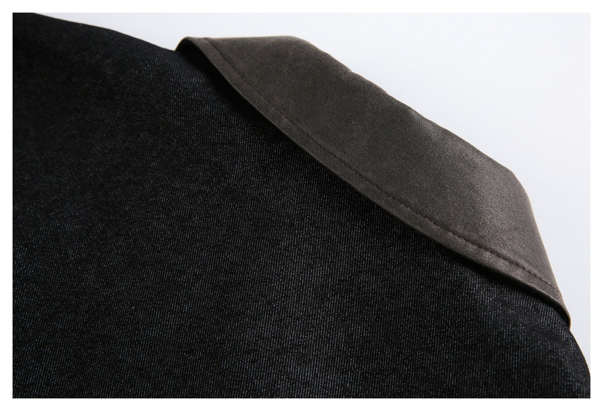 Close-up of a dark folded fabric edge against black garment fabric.