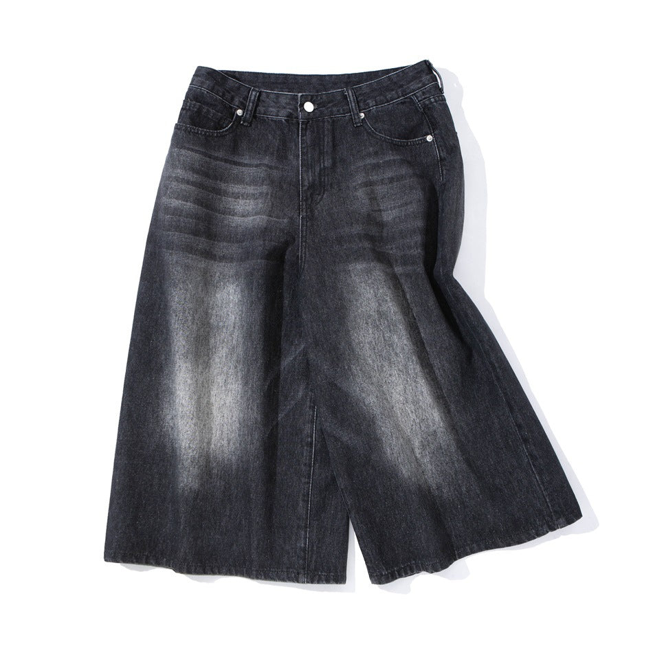 Front view of black wide-leg denim shorts with faded highlights, belt loops, and front pockets.