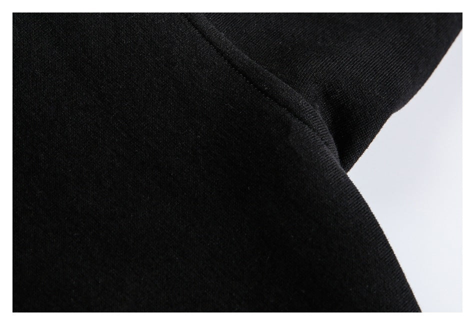 Close-up of black fabric and a curved stitched seam.