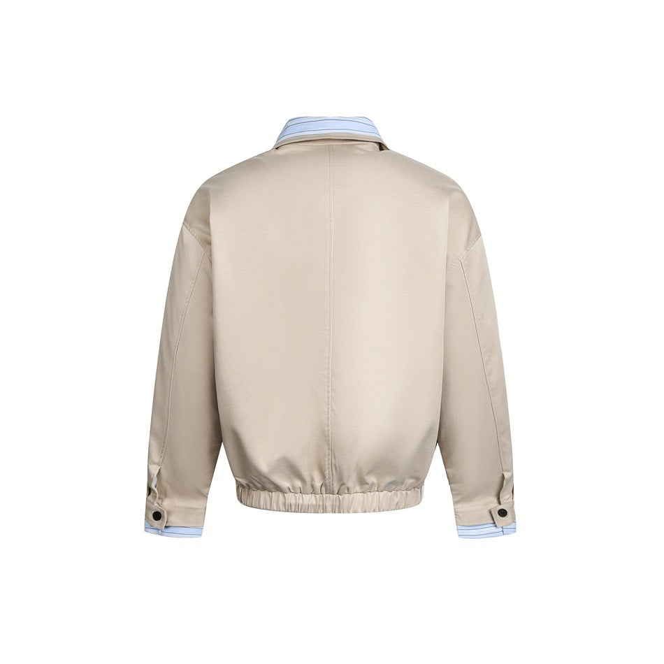 Back product view of a beige jacket with a center seam, elastic hem, and blue striped collar and cuffs.