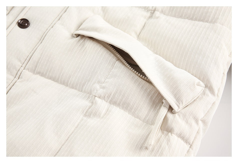 Close-up of an ivory jacket pocket with a partially covered zipper.
