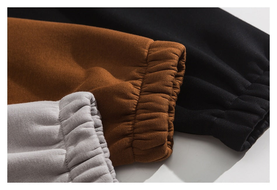 Close-up of gathered cuffs in brown, black, and light gray fabric.