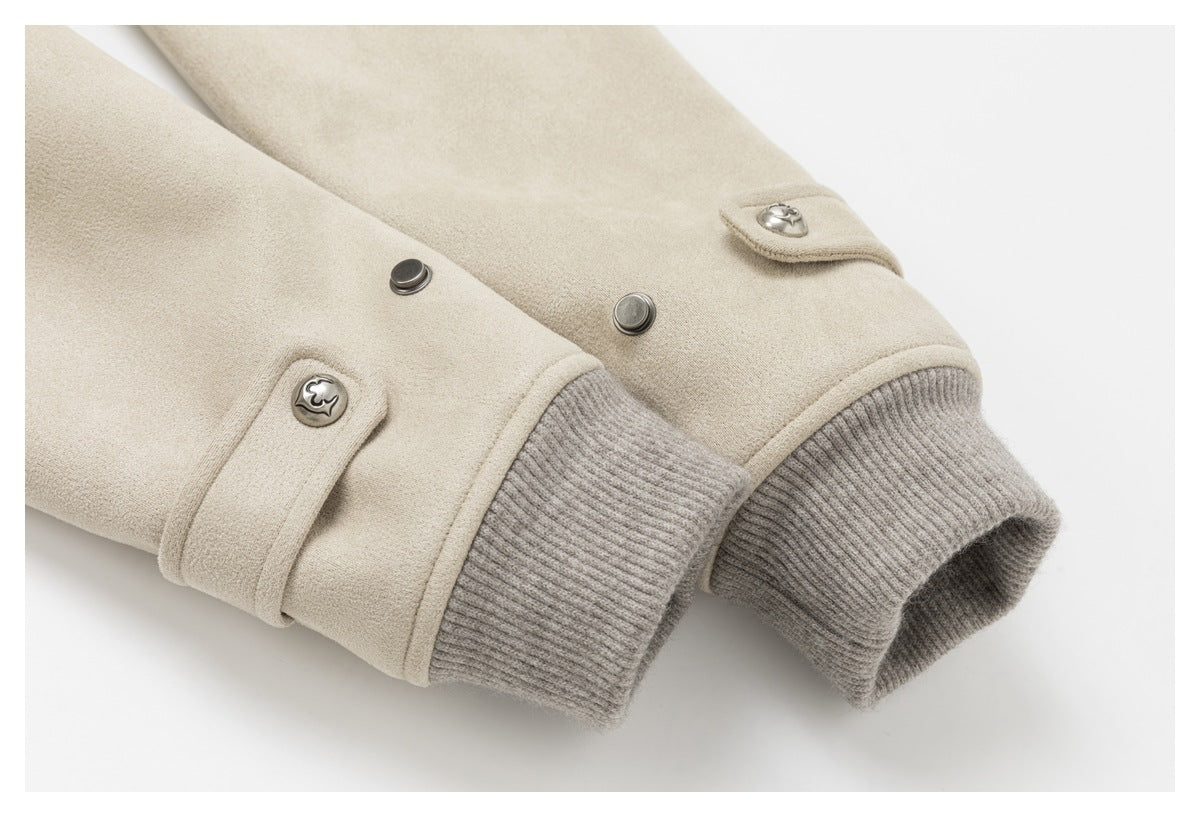 Close-up of a cream jacket sleeve with gray ribbed cuffs, snap buttons, and buttoned tabs.