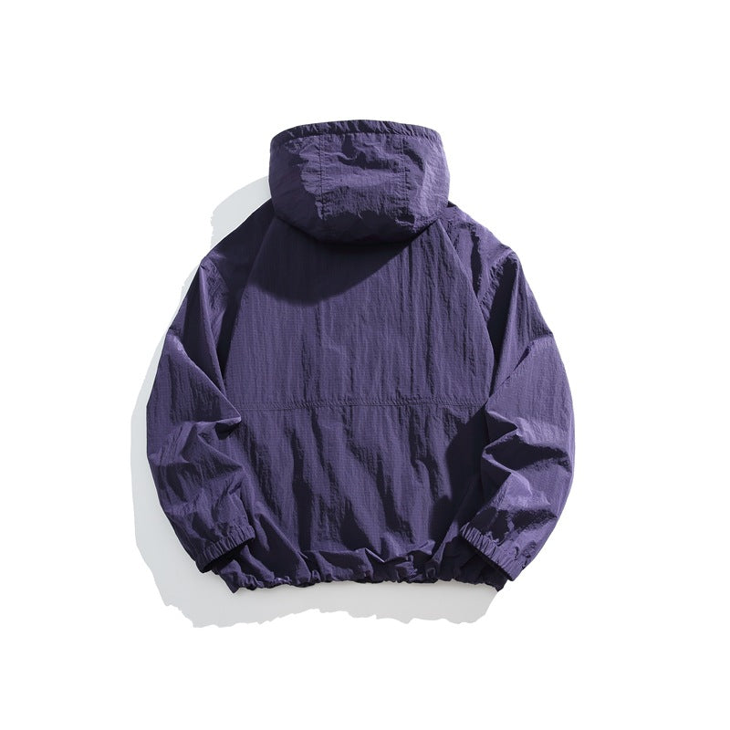 Rear view of a dark purple hooded jacket with elastic cuffs and hem.