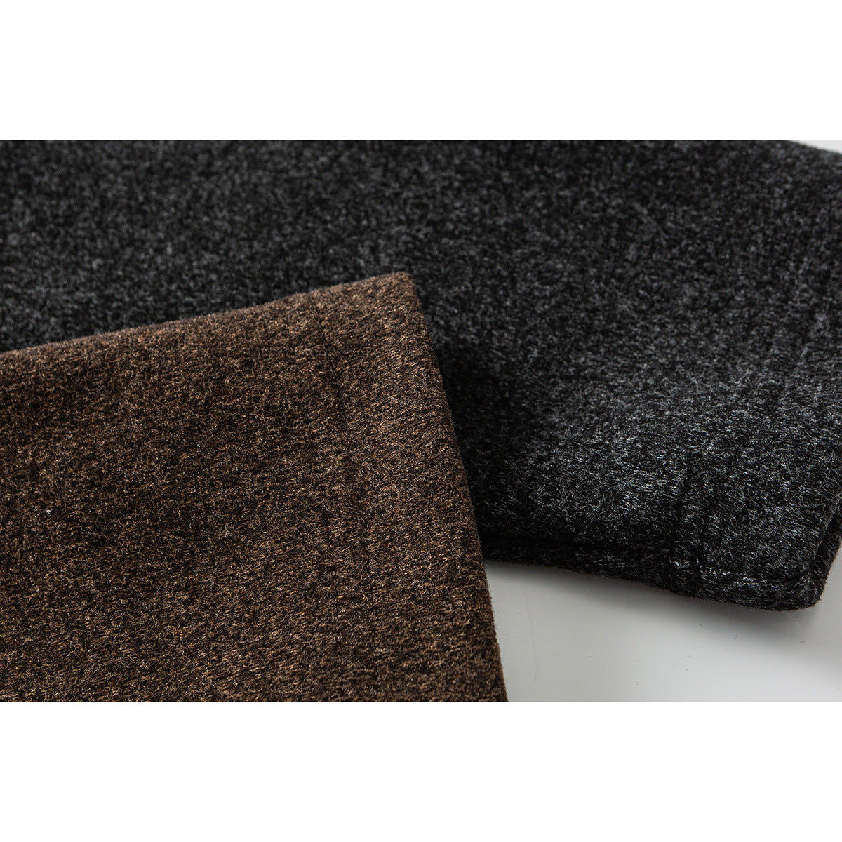 Close-up of charcoal and brown heathered fabric, including a stitched cuff edge.