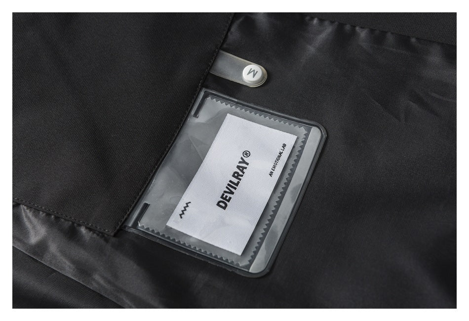 Close-up of a black jacket’s inner label pocket with a visible DEVILRAY garment label.