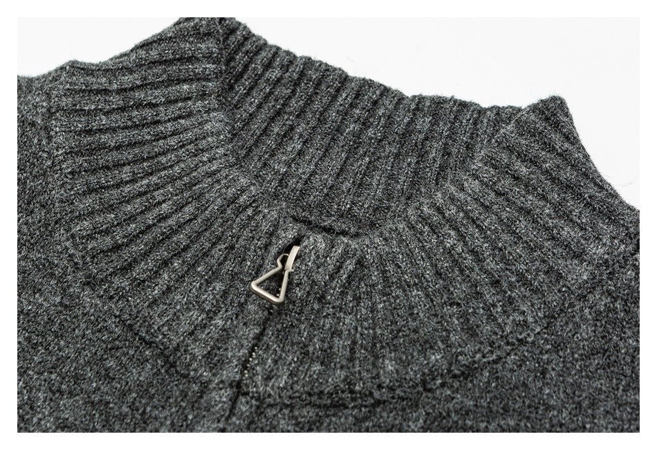 Close-up of the charcoal sweater's ribbed high collar and metal zipper pull.