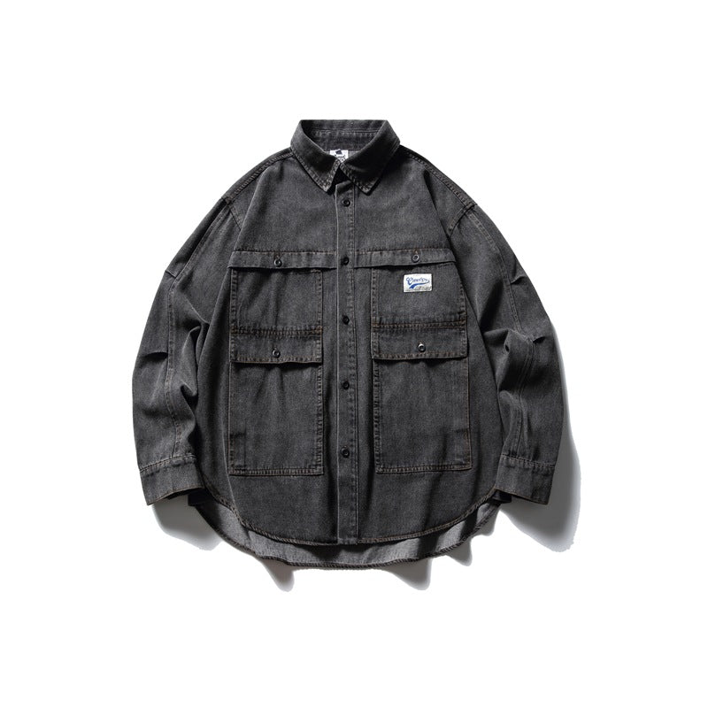 Washed black denim shirt jacket flat lay with collar, button front and two large flap chest pockets