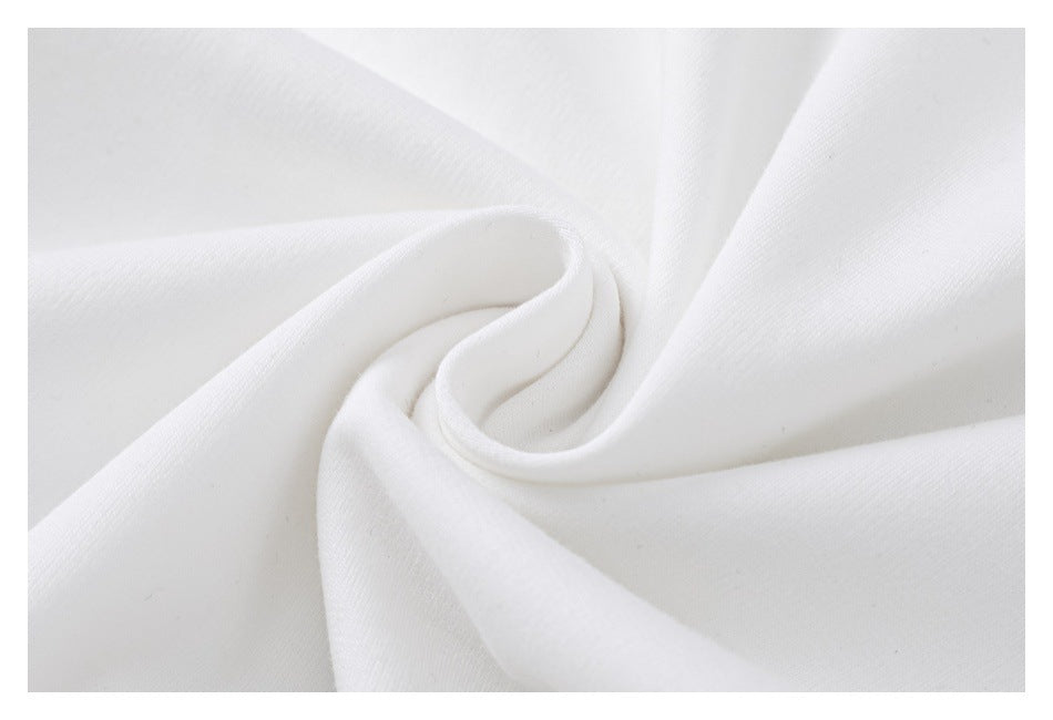 Close-up of white fabric arranged in soft folds, showing its surface texture.