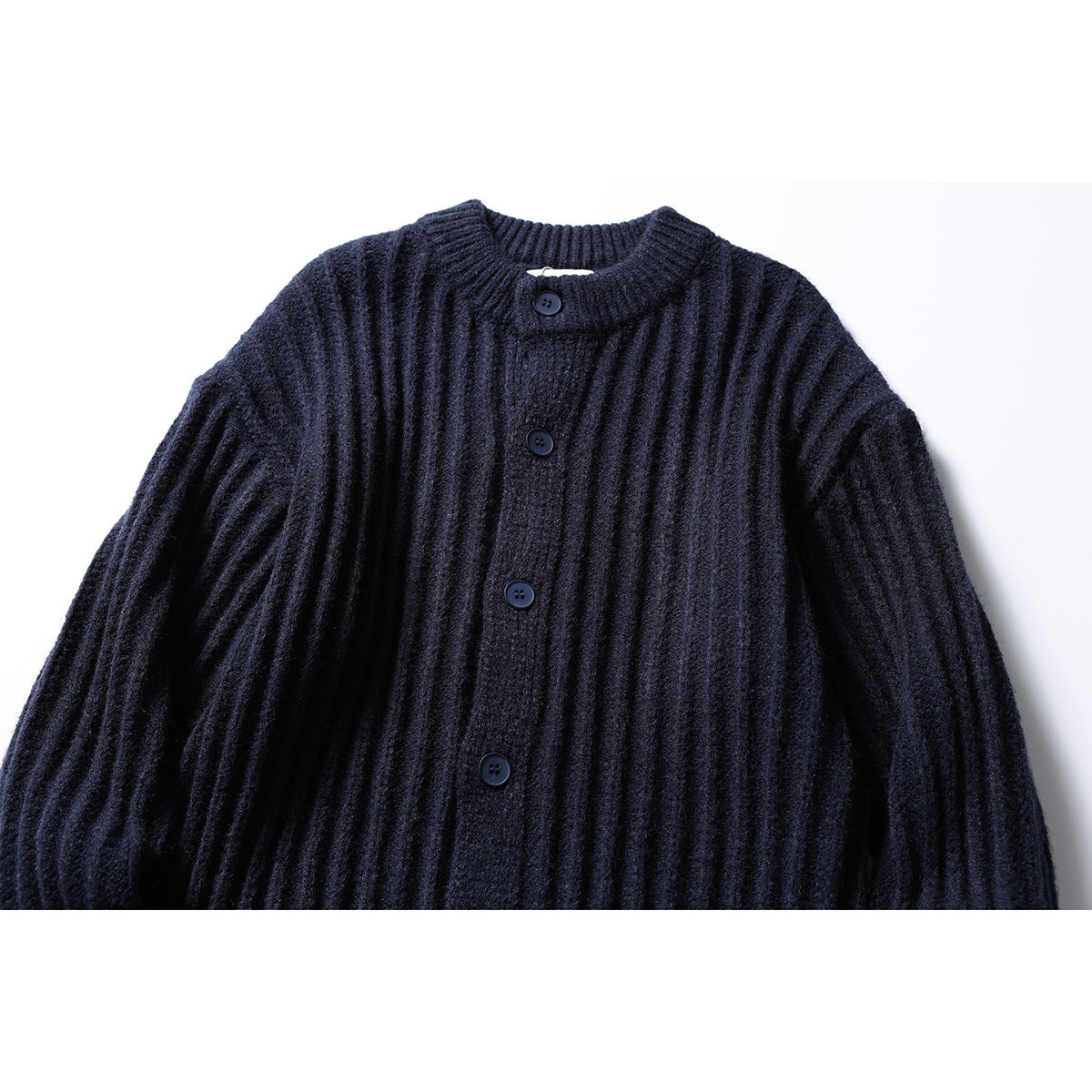 Close-up front of a dark navy ribbed cardigan with a short stand collar and button placket.