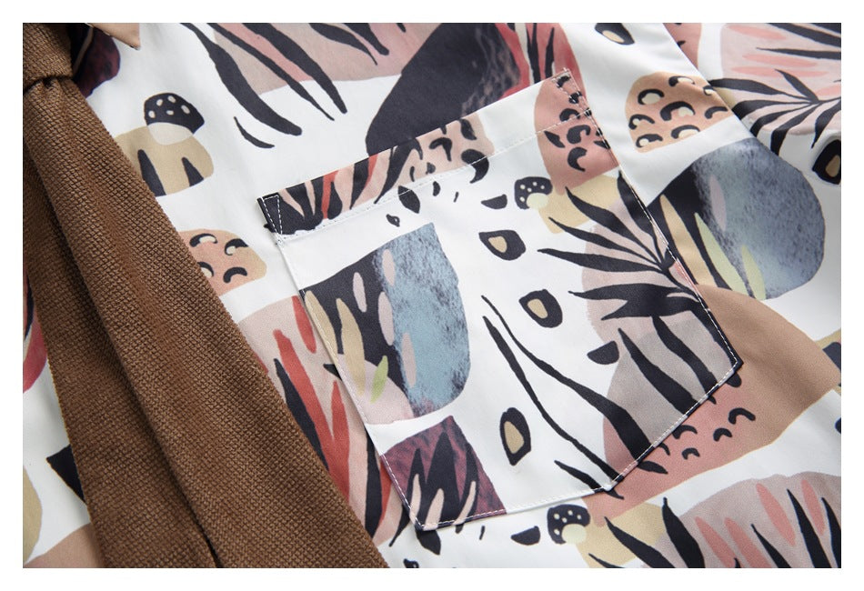 Close-up of a square chest pocket on the shirt, showing its abstract botanical print and stitching.