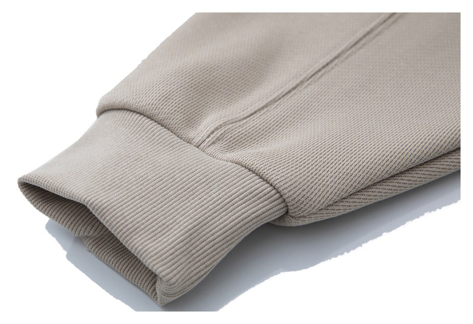 Close-up of a beige garment sleeve with a wide ribbed cuff.
