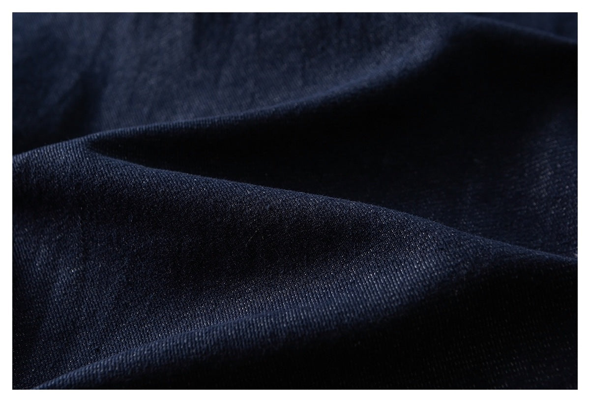Close-up of folded dark navy fabric showing its fine surface texture.
