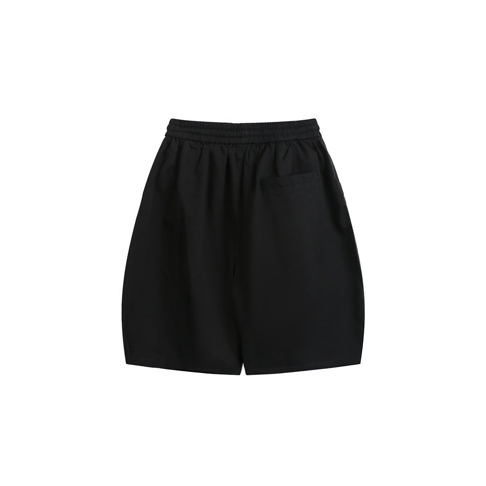 Back view of black shorts with an elastic waistband and a small rear pocket.
