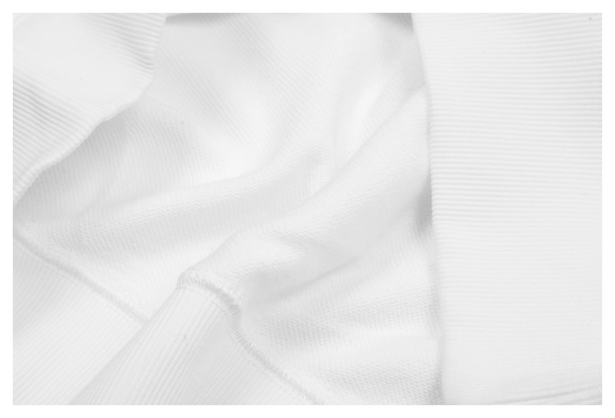 Close-up of white knit fabric with ribbed sections and a visible seam.