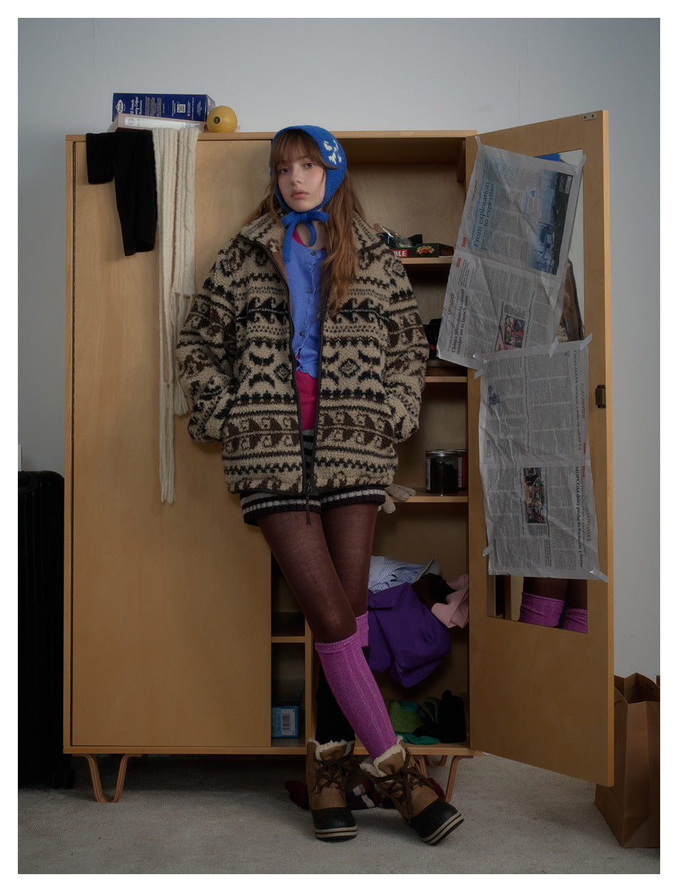 Front view of a model wearing a beige and black patterned cardigan with a blue bonnet.