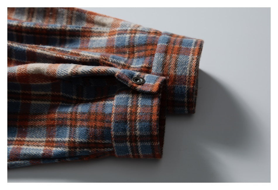 Close-up of the plaid shirt's buttoned cuff and sleeve opening.