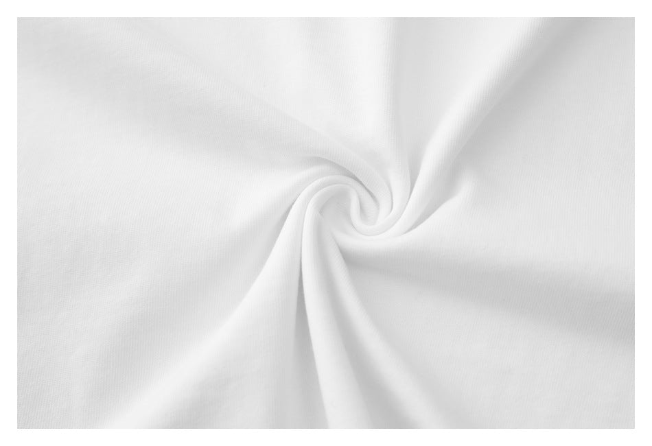 Close-up of white T-shirt fabric gathered into a small twist, showing its surface and drape.