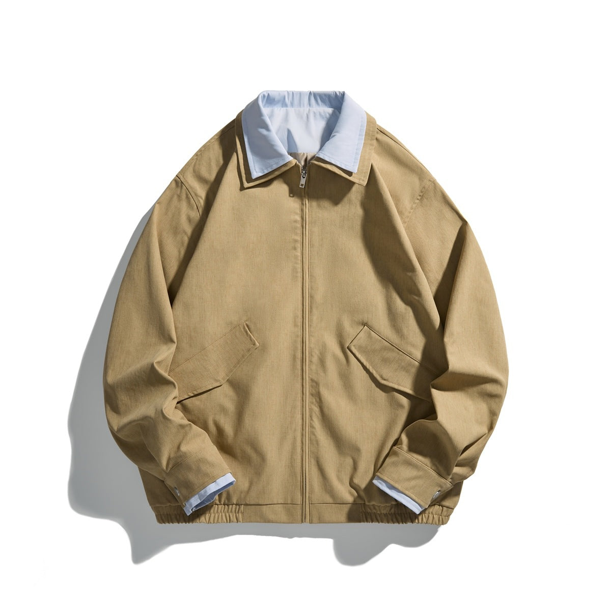 Khaki zip-front collared jacket with light blue inner collar, flap pockets and elastic hem, flat lay