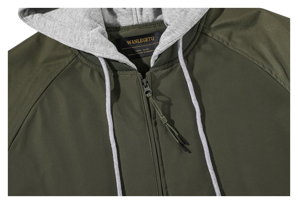 Close-up of the olive jacket's front zipper and drawstrings beneath a gray hood, with the neck label visible.