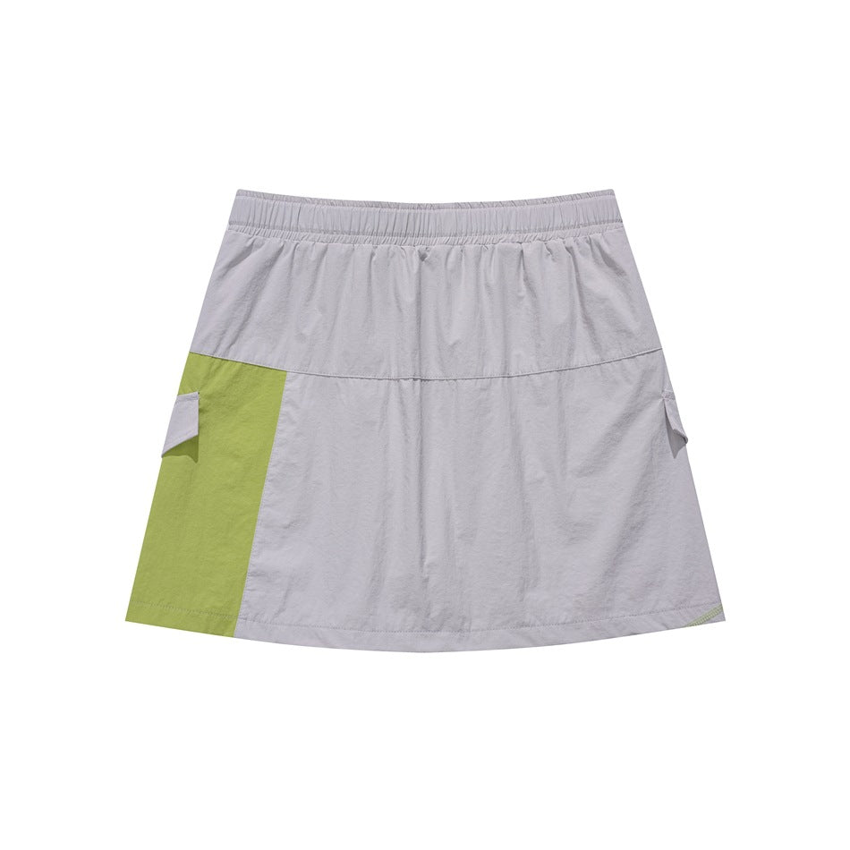 Front view of a light gray A-line skirt with an elastic waistband and a lime green side panel and pocket flaps.