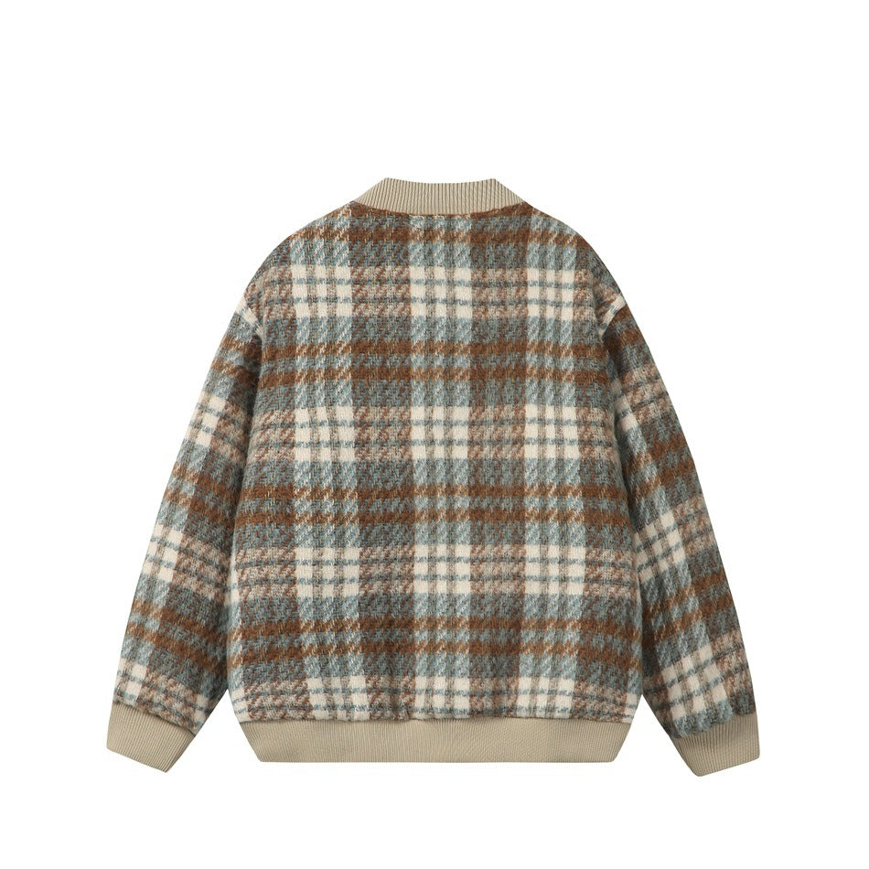 Back of a blue-gray, cream, and rust plaid jacket with beige ribbed collar, cuffs, and hem.