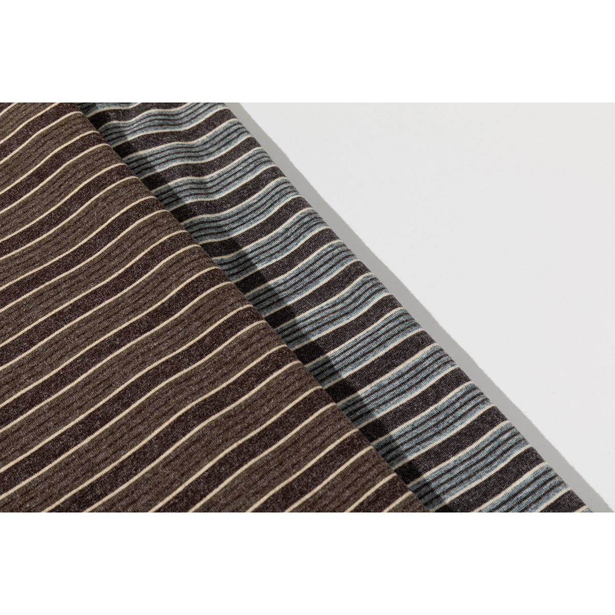 Close-up of brown and blue-gray striped T-shirt fabric laid side by side.