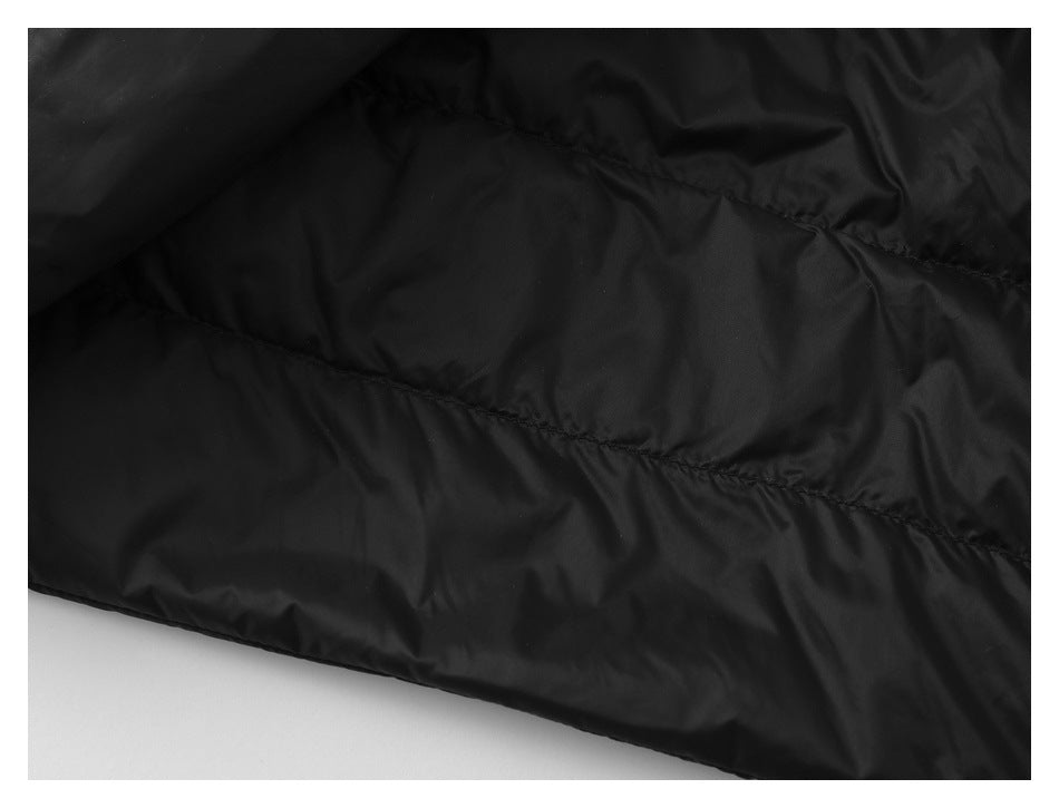 Close-up of black padded garment fabric with diagonal stitched seams.