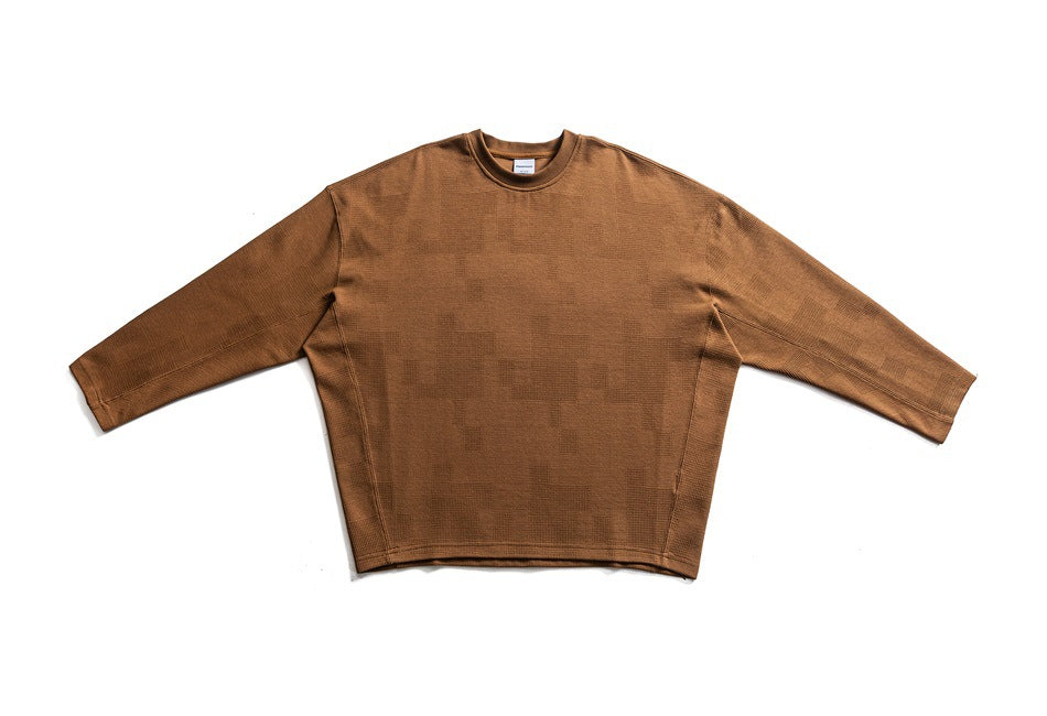 Front view of a camel-brown long-sleeve crewneck top laid flat with sleeves extended.