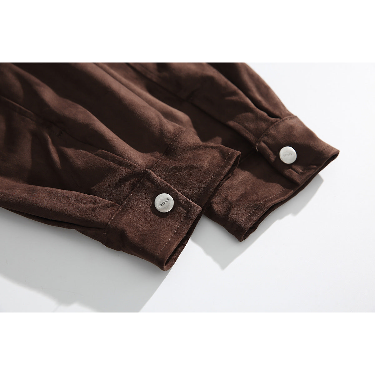 Close-up of the dark brown jacket's sleeve cuffs, each with a silver button.
