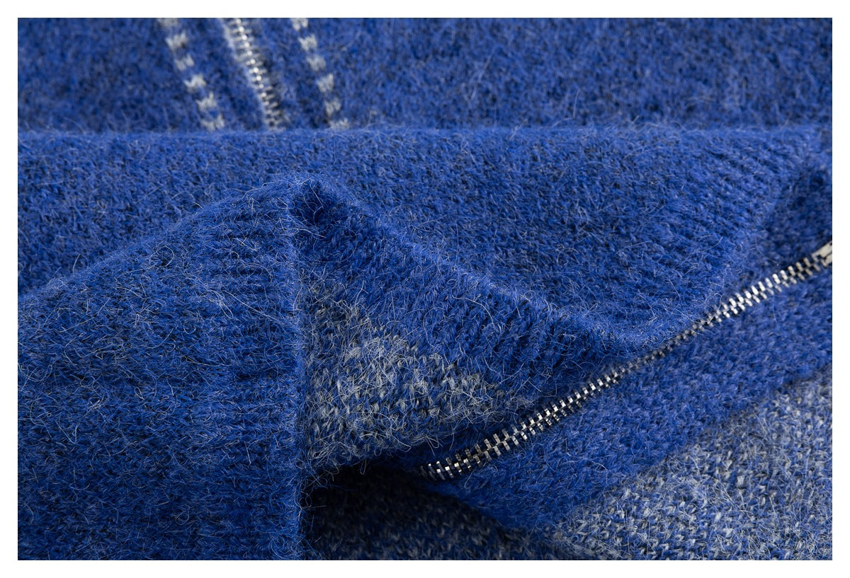 Close-up of the blue knit sweater fabric folded beside its metal zipper.