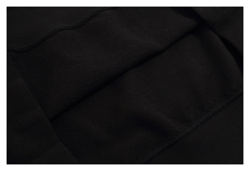 Close-up of the black sweatshirt’s inner fabric and ribbed trim.