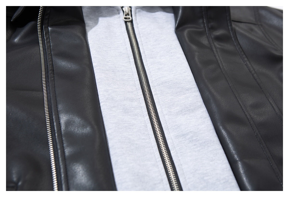 Close-up of the jacket's front zipper, black outer panels, and light gray inner hooded layer.