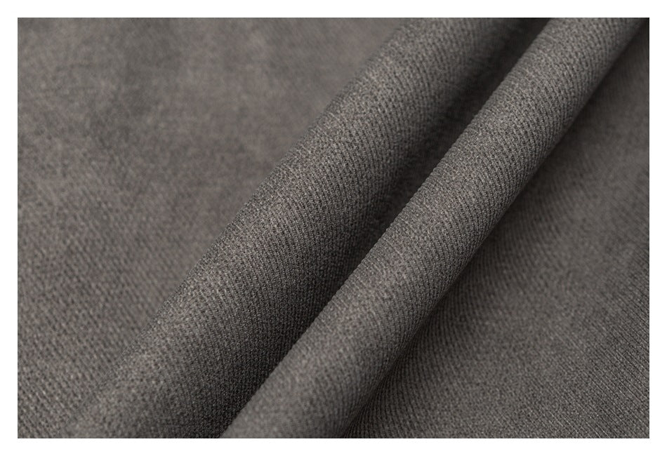 Macro view of charcoal gray fabric draped into soft folds.