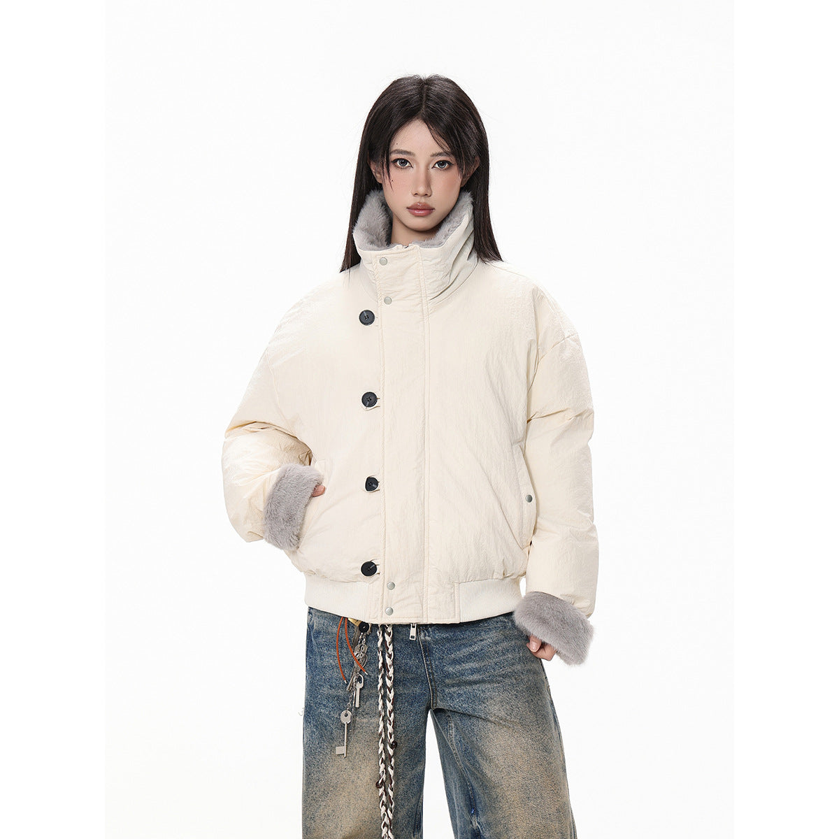 Front view of an ivory jacket with a high gray faux-fur collar and cuffs, worn with blue jeans.