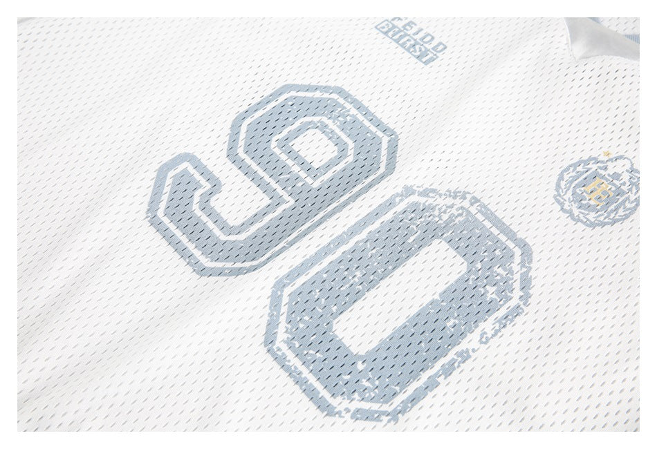 Close-up of the white mesh jersey's pale blue-gray number 90 graphic and small crest.