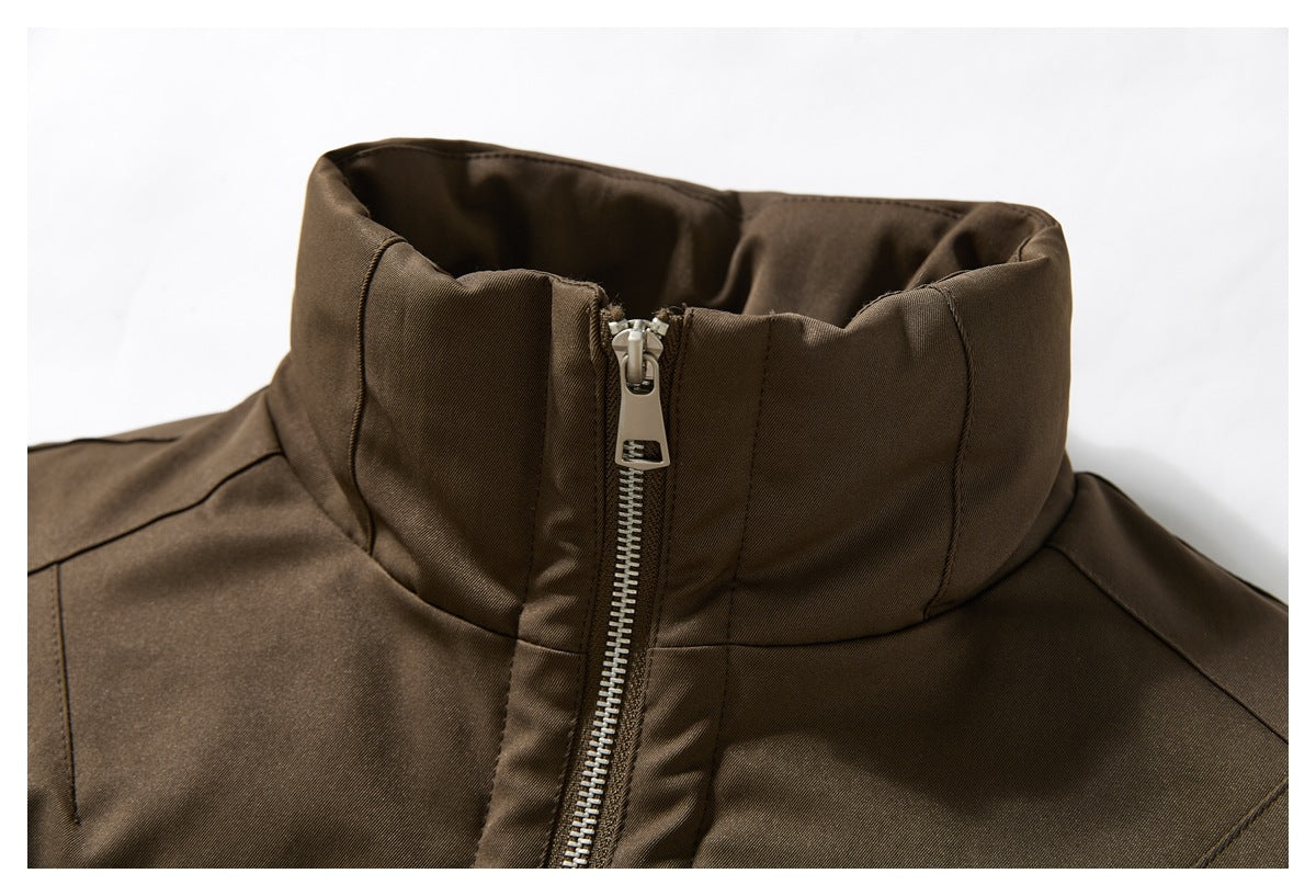 Close-up of a dark brown jacket’s tall stand collar and silver front zipper.