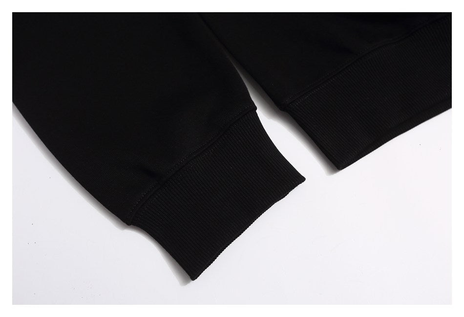 Close-up of the black sweatshirt's long sleeves and wide ribbed cuffs.