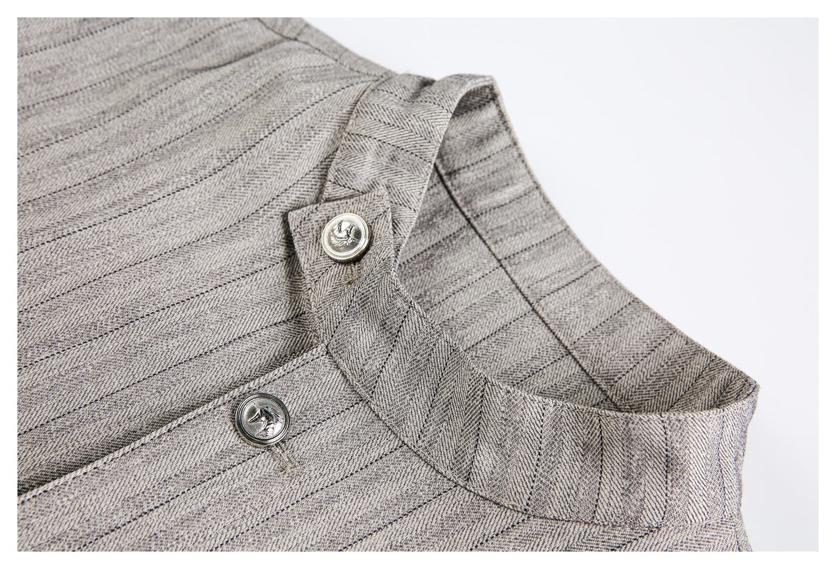 Close-up of the jacket's stand collar, pinstriped fabric, and silver buttons.
