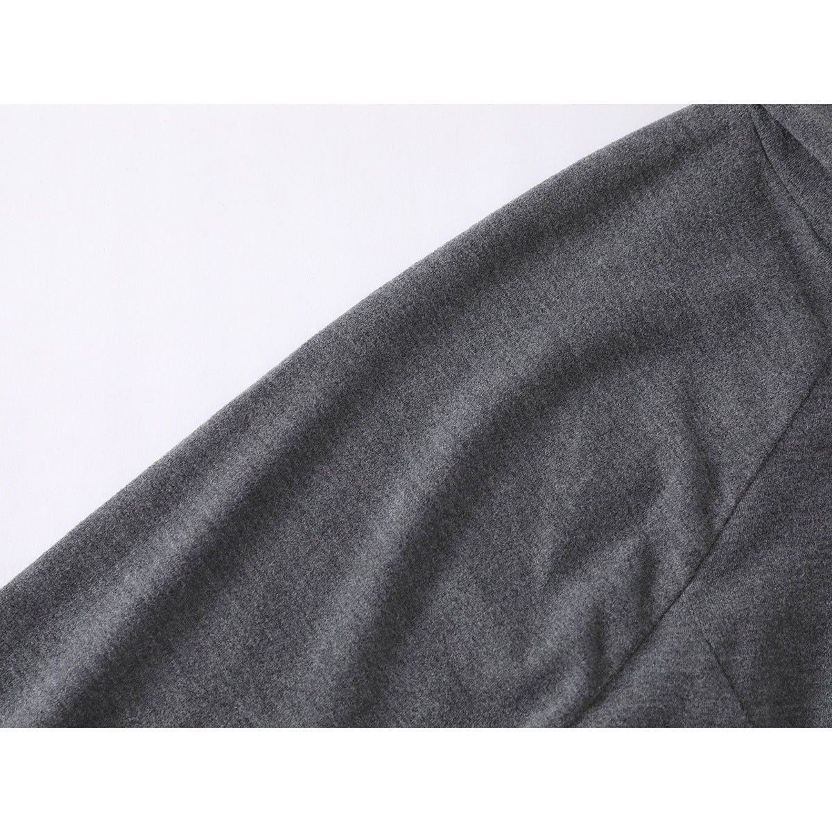 Close-up of a charcoal gray sleeve and its stitched seam.