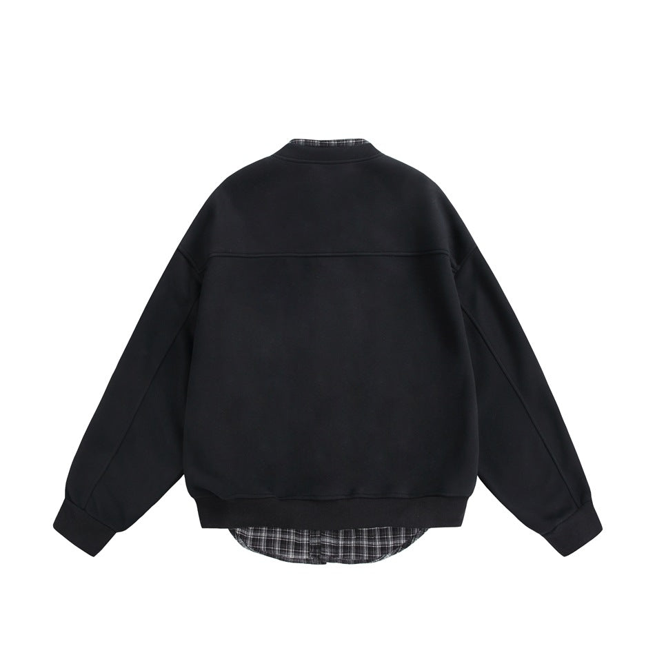 Back view of a black jacket with long sleeves, ribbed cuffs and hem, and plaid lining peeking at the collar and hem.