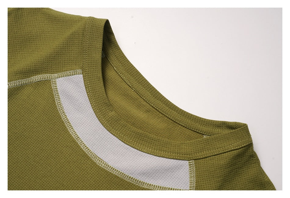 Close-up of an olive-green garment's rounded neckline and white contrast seam panel.