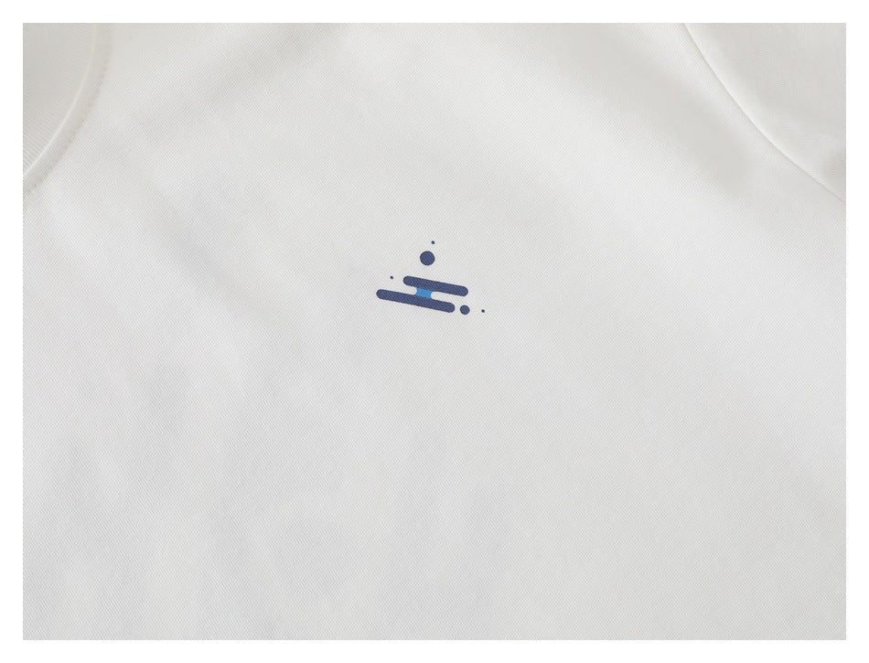 Close-up of a small navy and blue abstract graphic printed on a white T-shirt.