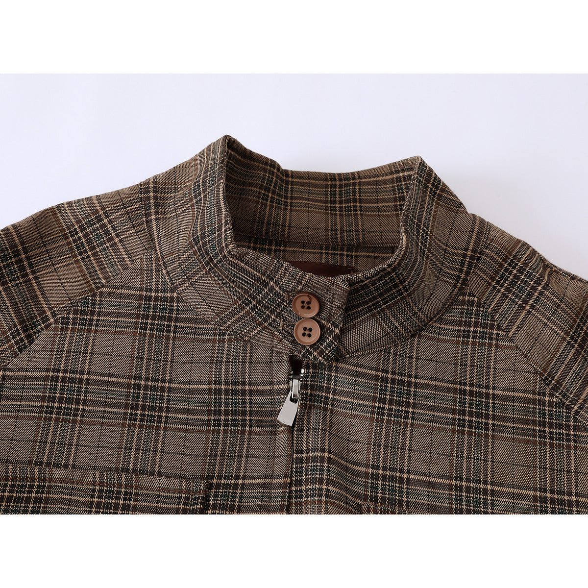 Close-up of a brown plaid jacket collar with two buttons and a silver zipper pull.