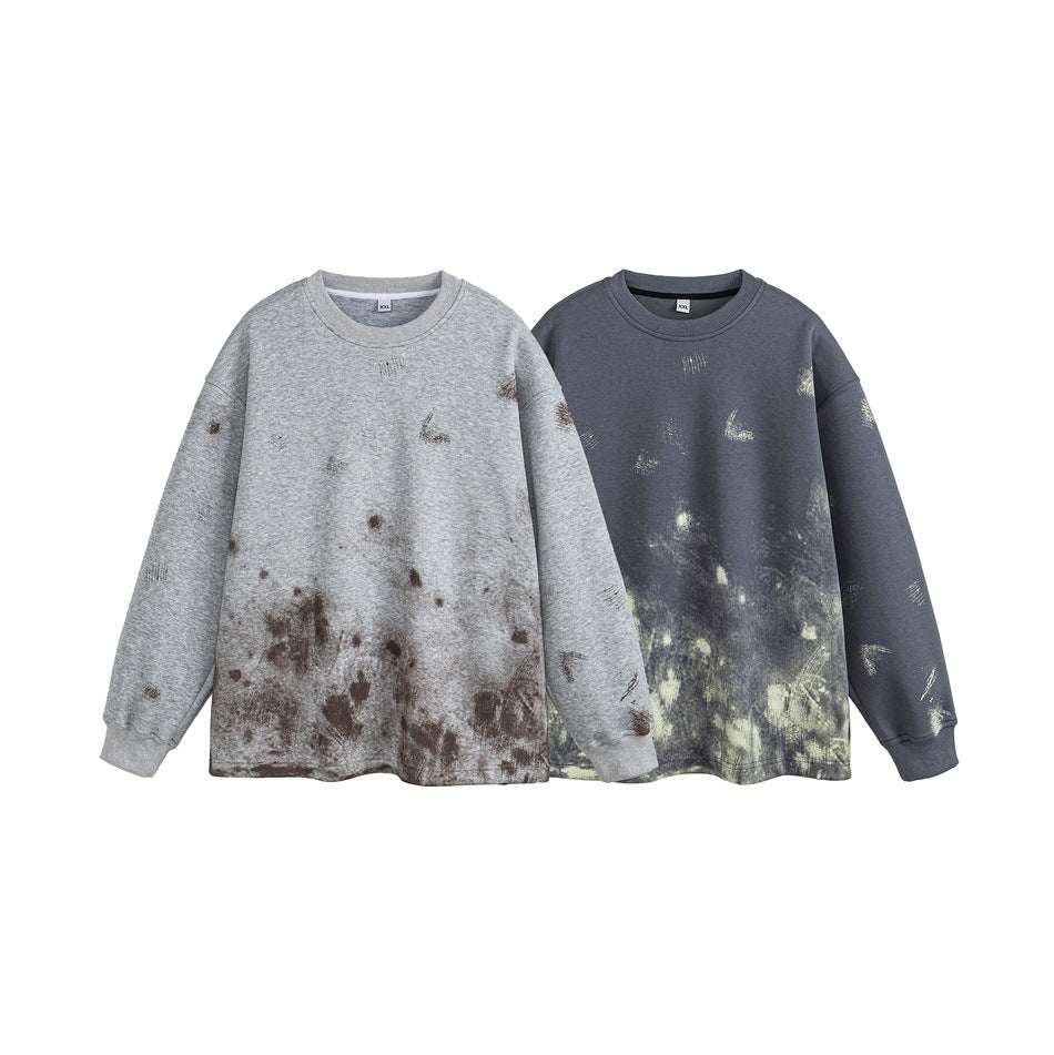 Two crewneck sweatshirts shown from the front in light gray and slate blue, both with distressed graphics.