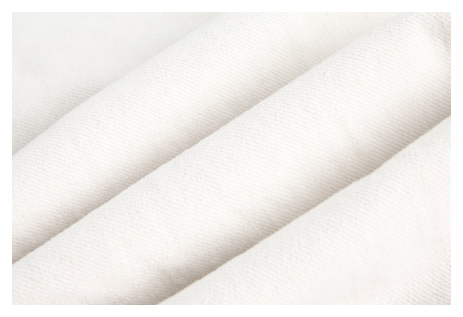 Macro view of the fine diagonal weave in ivory fabric.