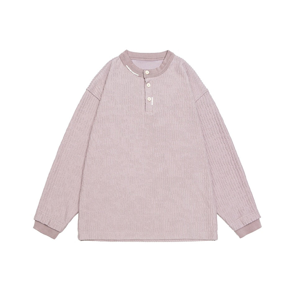 Dusty mauve ribbed long-sleeve Henley top with three buttons and ribbed cuffs, flat lay on white