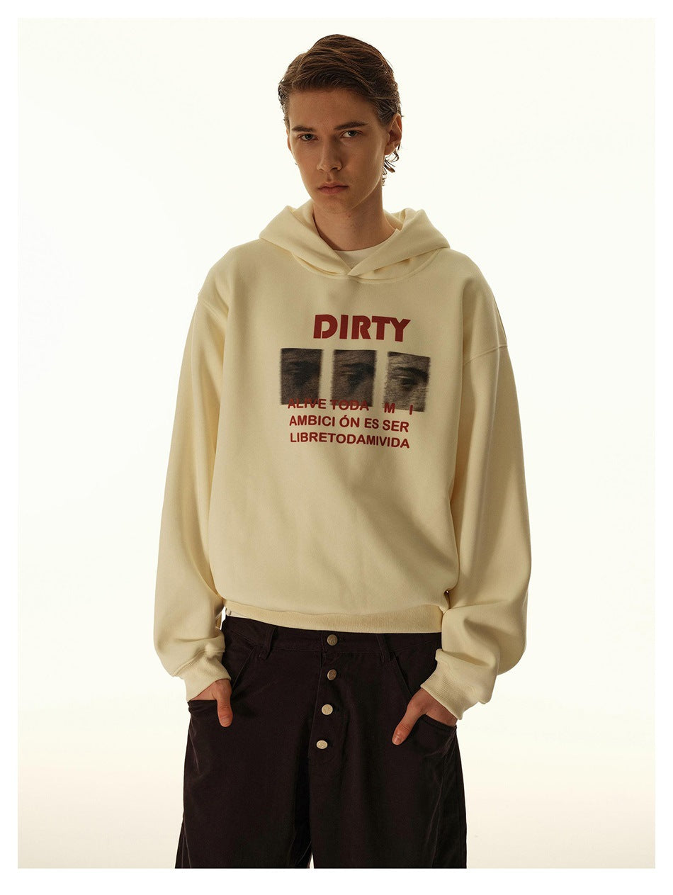 Model wearing an off-white graphic hoodie with dark brown wide-leg pants, hands in pockets, close-up